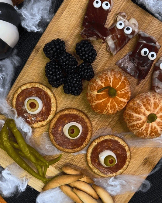 Halloween charcuterie board with Spanish cured meats, cheese, olives and sweets